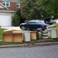 Does the cost of using a junk removal service include disposal fees for the items removed from my property?